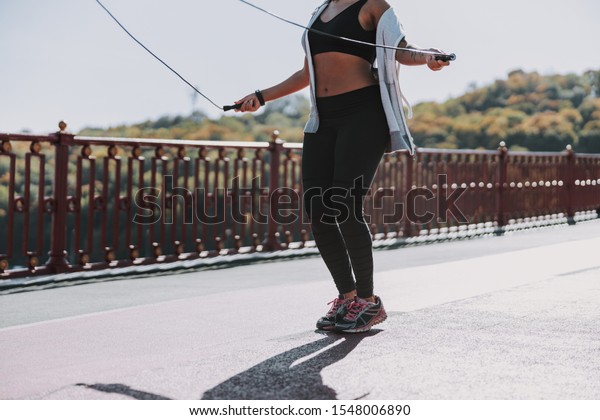 Athletic Afro American lady exercising on the\
bridge stock photo
