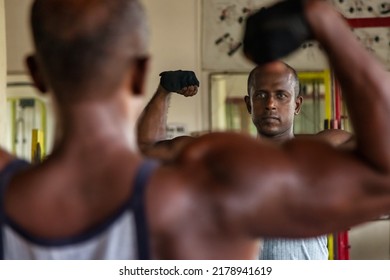 Athletic Asian Man Posing Muscle Workout At Mirror. Portrait Bodybuilder Man Looking Reflection At Old Gym. Sportsman Standing And Arms Raised. Sports And Bodybuilding Concept. Healthy Lifestyle