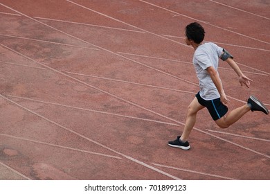 Athletic Asian Runner Sprinter Crossing The Finish Line.