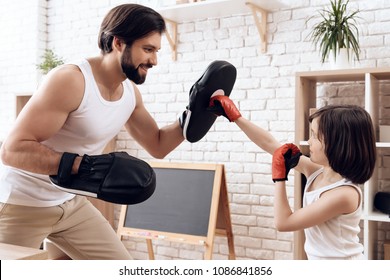 Athletic Bearded Father Teaches Son To Box. Man Coaches Child To Strike. Concept Of Self Defense Training.