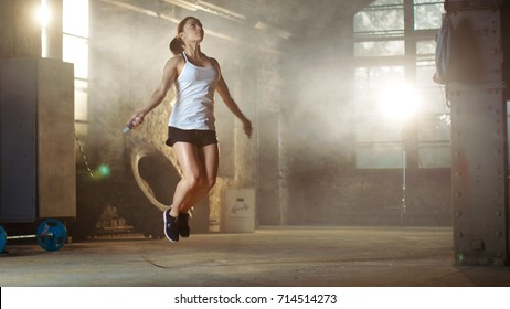 Athletic Beautiful Woman Exercises with Jump / Skipping Rope in a Gym. She's Covered in Sweat from Her Intense Fitness Training. - Powered by Shutterstock