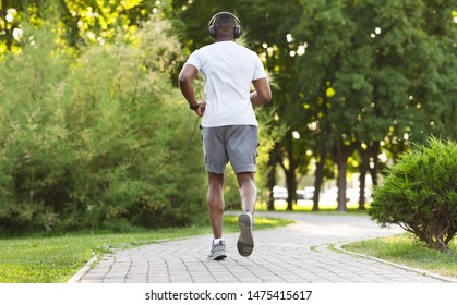 Athletic Black Guy Running In The Park, rear view, copy space - Shutterstock ID 1475415617