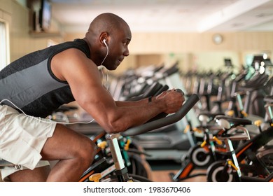 Athletic Black Man Doing Cardio Workout On Exercise Bike In Gym. Concept Of Sport And Healthy Lifestyle.