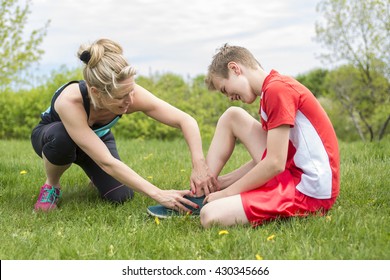 An Athletic Boy Holding Her Painful Ankle