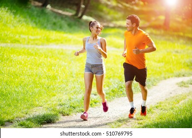 Athletic couple jogging in nature in good spirit - Shutterstock ID 510769795