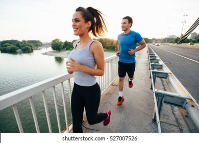 Athletic Couple Jogging Together Outdoors