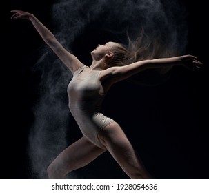 Athletic dancer in cloud of powder on the scene