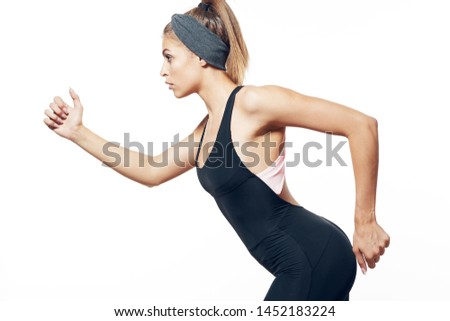 Athletic figure of a young woman with a bandage on her head runs forward Olympic Games cropped look