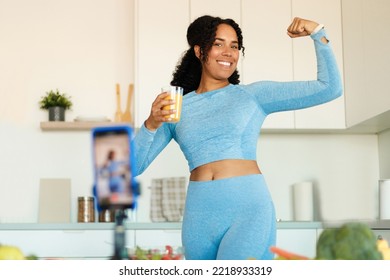 Athletic Fitness Coach Filming Video Blog. African American Woman Sharing Dieting And Eating Habits Tips, Recording Vlog On Smartphone And Showing Fit Body