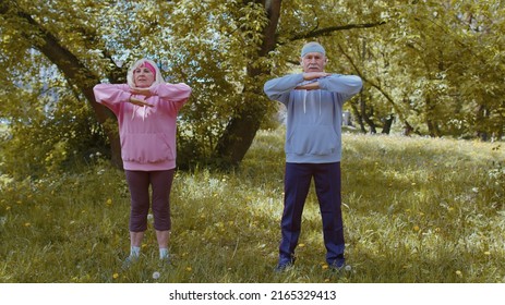 Athletic Fitness Senior Elderly Sport Man Woman Training Cardio Workout Sretching In Summer Park At Morning. Old Grandparents Enjoying Working Out Healthy Lifestyle. Active Retired People Motivation