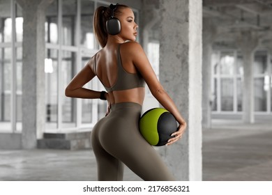 Athletic Girl Working Out In Gym. Fitness Woman Training With Medicine Ball