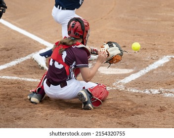 Athletic Girls In Action Playing In A Softball Game