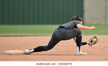 Athletic Girls In Action Playing In A Softball Game