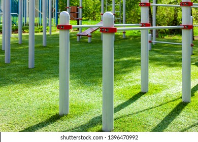 Athletic Gym At Outdoor, Green Sport Yard. Concept Exercising On Horizontal Bar Outdoors, Workout.