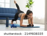Athletic Healthy Asian young woman in sportswear workout legs excercise at home.Young female with slim body cardio aerobic exercises for healthy wellness life.Healthy lifestyle concept