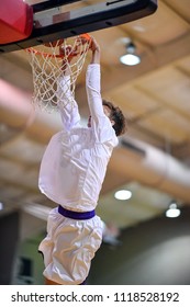 Athletic High School Basketball Player Making A Slam Dunk