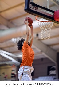 Athletic High School Basketball Player Making A Slam Dunk