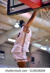 Athletic High School Basketball Player Making A Slam Dunk