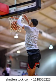 Athletic High School Basketball Player Making A Slam Dunk