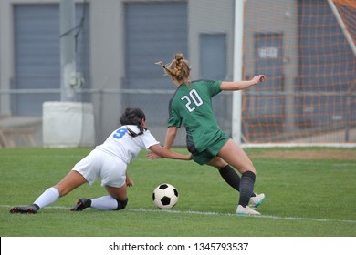 Athletic High School Girls Playing A Competitive Varsity High School Soccer Game.