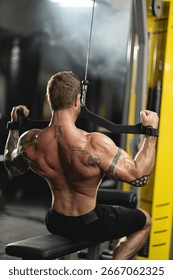 athletic individual executes a front pulldown exercise targeting his back and shoulders. He is focused and determined showcasing his muscular physique in an indoor gym environment.