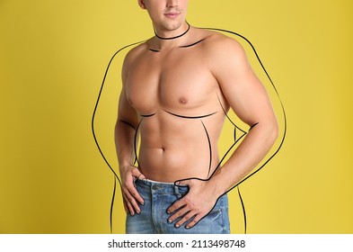 Athletic man after weight loss on yellow background, closeup view