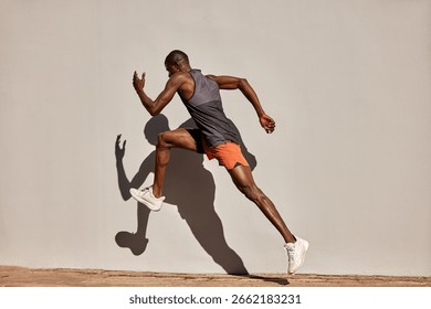 Athletic man captured in motion during an energetic outdoor running exercise