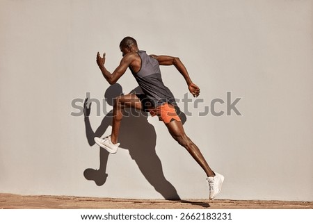 Athletic man captured in motion during an energetic outdoor running exercise