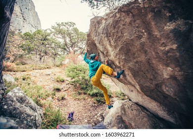 Athletic Man Climbing Hard Boulder Problem In Forest. Sport Climbing, Bouldering. Outdoor. Top View Of Gripping Hand.