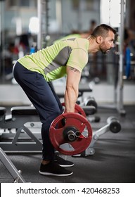 Athletic Man Doing Barbell Row In The Gym For Back Workout