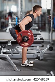 Athletic Man Doing Barbell Row In The Gym For Back Workout