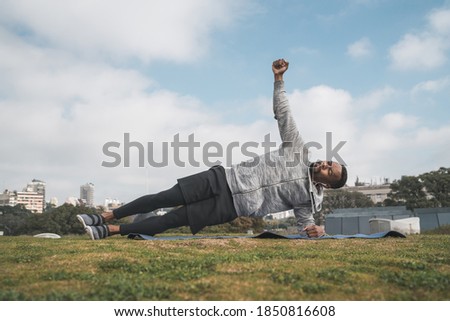 Similar – Black man practicing yoga in urban background.