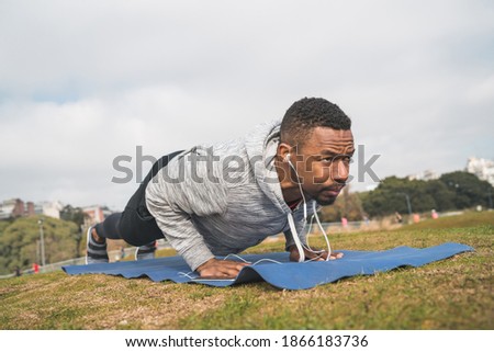 Athletic man doing push ups.