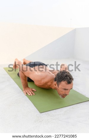 Athletic man doing pushups exercise at home