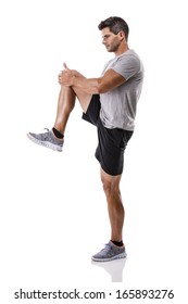 Athletic man doing some warming exercises, isolated over a white background