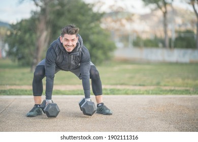 Athletic Man Doing Squat And Back Exercise And Cross Training With Dumbbells