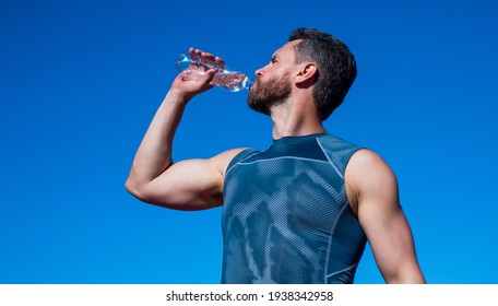athletic man drinking water because of thirst after training, sport and health
