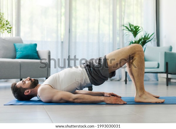 Athletic man exercising at home, fitness and\
sports concept