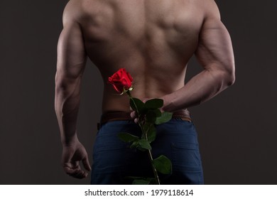 Athletic Man Holding A Red Rose Behind His Back. Love And Romance Relationships Concept