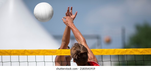 Athletic man jumping to make wall block at beach volleyball net. Horizontal sport theme poster, greeting cards, headers, website and app
 - Powered by Shutterstock