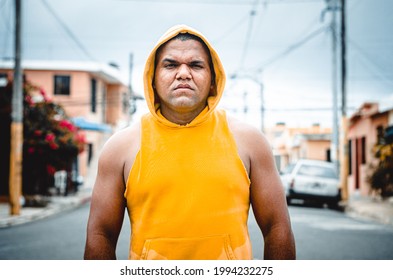 Athletic Man Of Latin Origin After Training With A Tough Attitude With A Yellow Sweater Or Walks With A Hood And A Bad Man's Face, Dominican Model In Sport