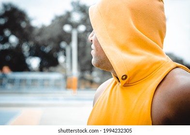 Athletic Man Of Latin Origin After Training With A Tough Attitude With A Yellow Sweater Or Walks With A Hood And A Bad Man's Face, Dominican Model In Sport