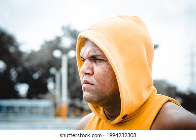 Athletic Man Of Latin Origin After Training With A Tough Attitude With A Yellow Sweater Or Walks With A Hood And A Bad Man's Face, Dominican Model In Sport