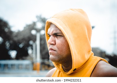 Athletic Man Of Latin Origin After Training With A Tough Attitude With A Yellow Sweater Or Walks With A Hood And A Bad Man's Face, Dominican Model In Sport