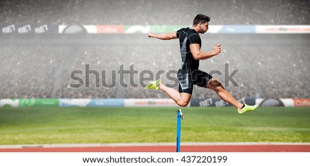 Athletic man practicing show jumping against view of a stadium