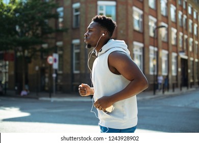 Athletic man running with earphones - Powered by Shutterstock