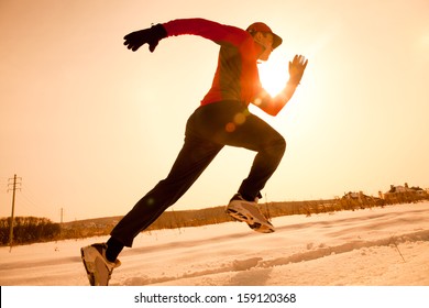 Athletic  Man Running In Winter Morning