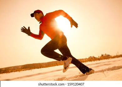 Athletic  Man Running In Winter Morning