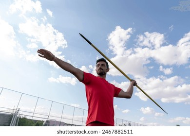 An athletic man throws the javelin in the stadium. - Powered by Shutterstock