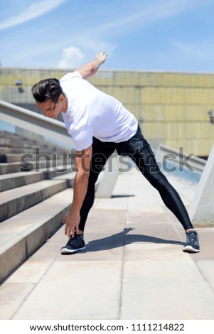 Athletic man warming up before running.